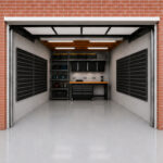 Open garage with brick exterior, showing a storage/workshop area inside with pegboard walls and shelves holding bins and tools.